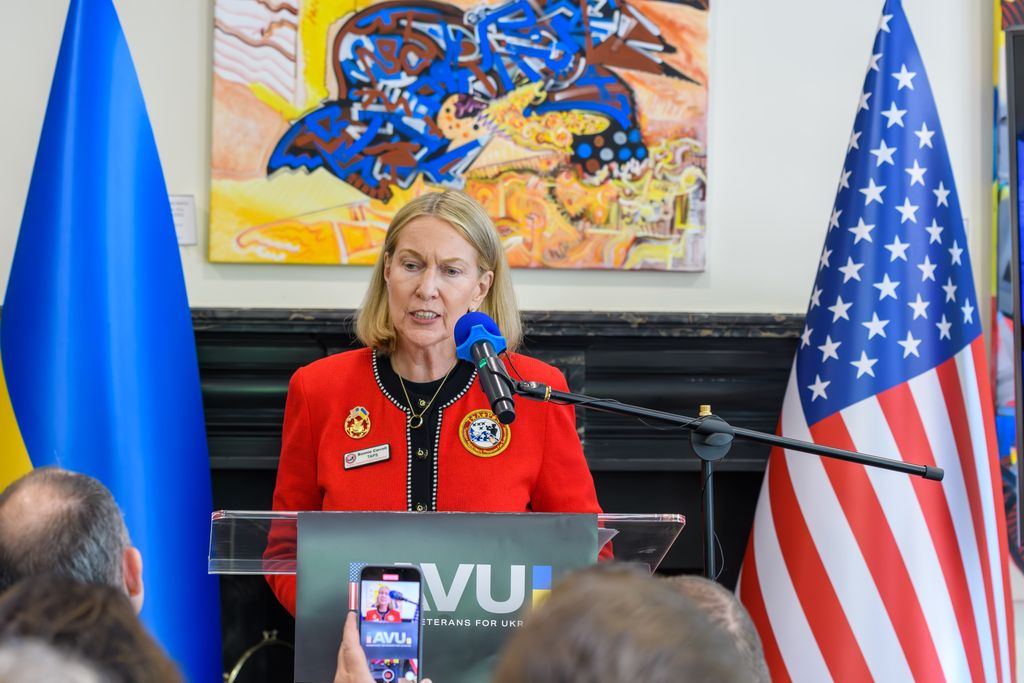 Remarks from the AVU podium between the Ukrainian and American flags
