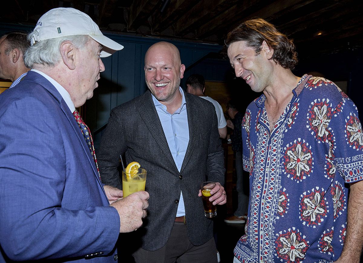 Guests share a laugh during the IVA launch reception