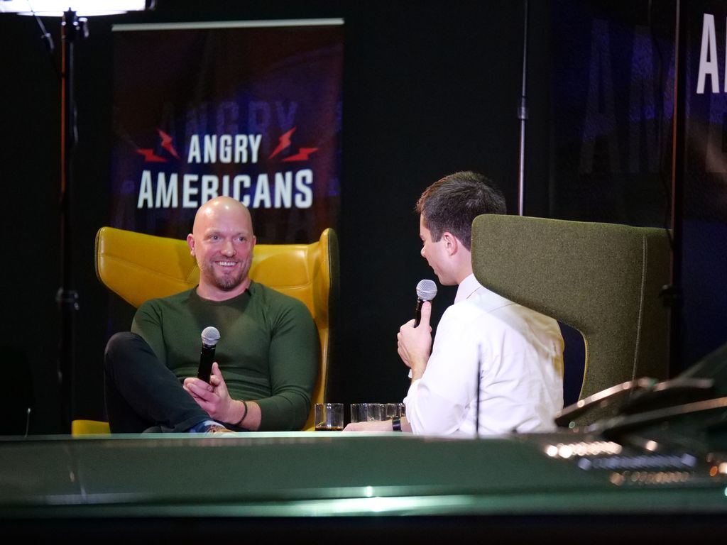 Paul Rieckhoff and Pete Buttigieg share a laugh on stage