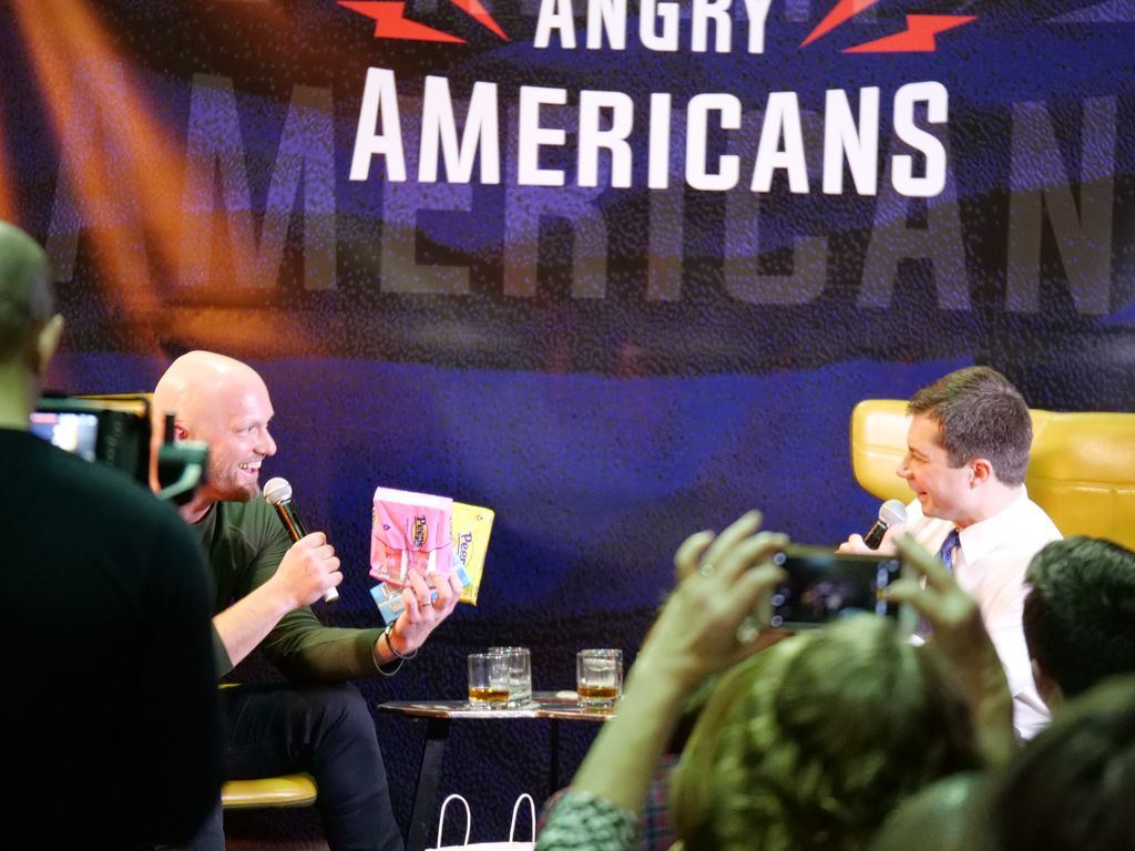 Guests photograph the stage during the Pete Buttigieg event