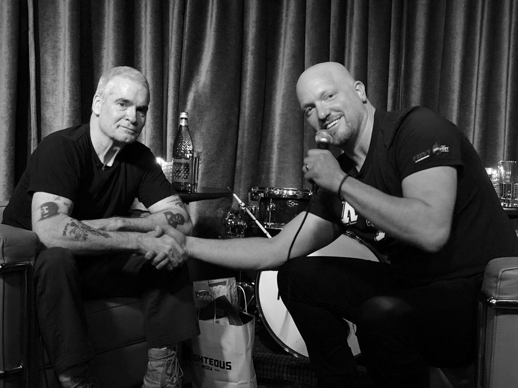 Henry Rollins and Paul Rieckhoff compare tattoos on stage